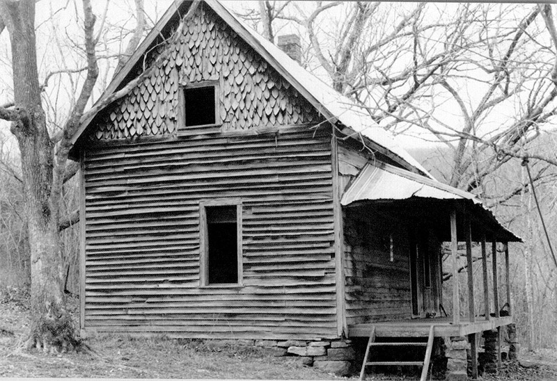 Side view of multistory cabin with covered porch