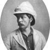 White man with mustache in suit with helmet