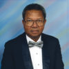 African-American man with glasses in suit and bow tie