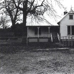 Single-story house with covered porch and fenced-in yard