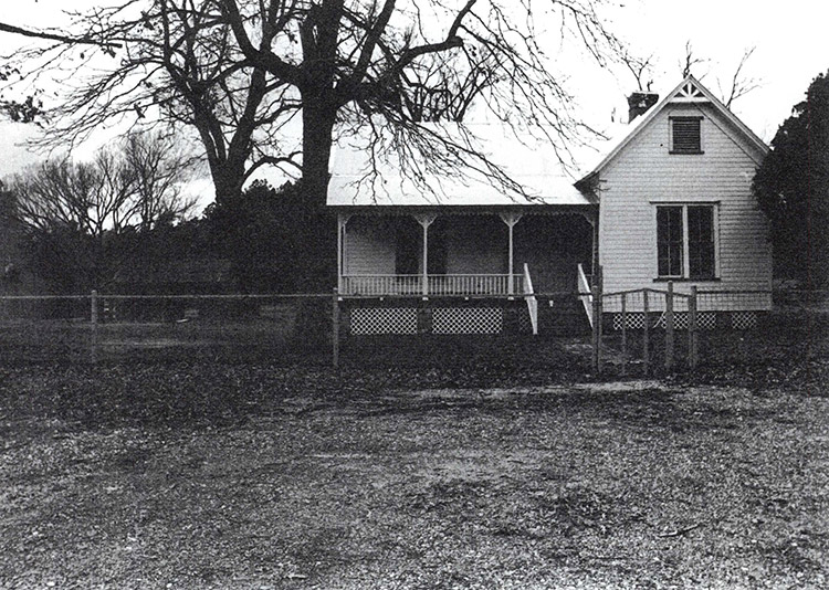 Single-story house with covered porch and fenced-in yard
