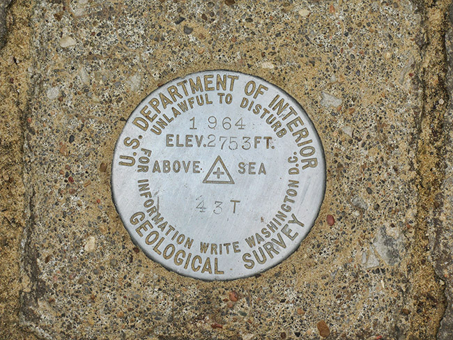 Round "U.S. Department of Interior Geological Survey" marker