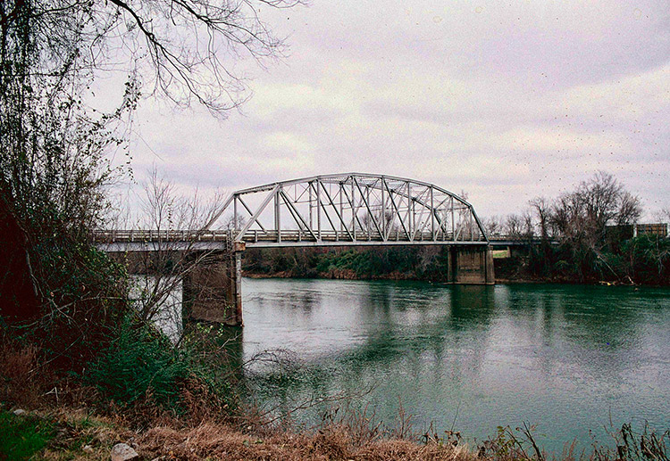 Steel arch truss bridge over river