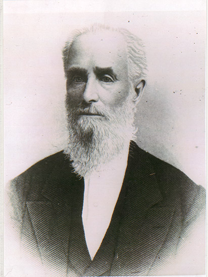 Old white man with long beard in suit and white shirt