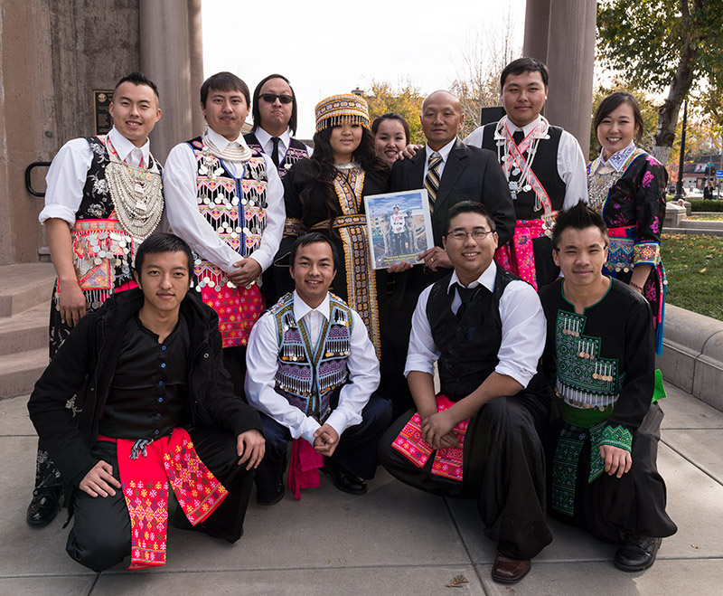 Group of Hmong men and women in traditional garb