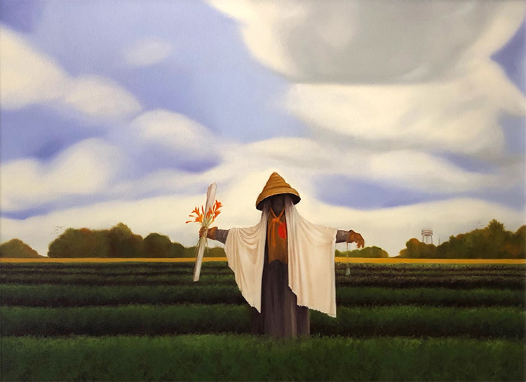 Scarecrow with conical hat and robes in green field with water tower and trees in the background