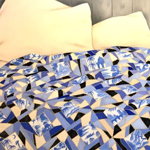 Blue and white quilt on bed with pillows
