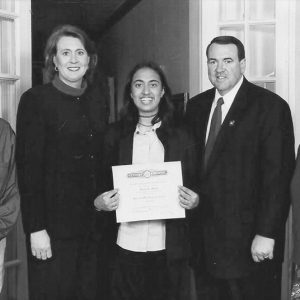 White man and woman posing with Indian man woman and young woman with diploma