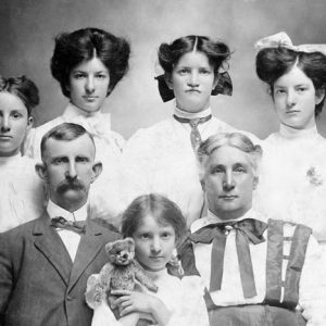 portrait of white family of seven in formal dress