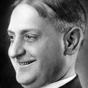 Side view of man smiling in suit and tie