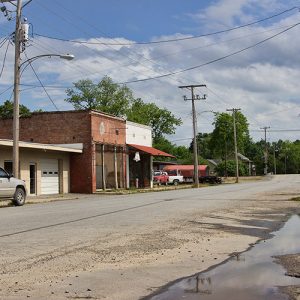 Brick storefronts and power lines on rural road