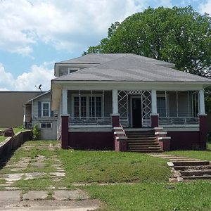 Front view of house with covered porch steps and driveway