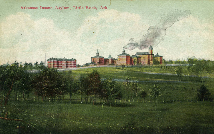 Multistory brick buildings on hill with fences and grounds on post card labeled "Arkansas Insane Asylum, Little Rock, Arkansas"
