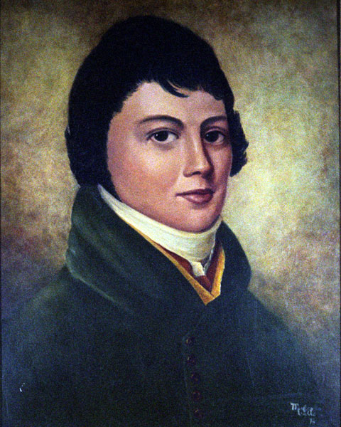 Young man with dark hair in a green suit and white collar