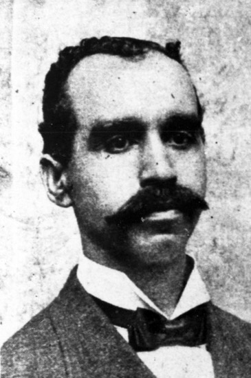 African-American man with mustache in suit and tie
