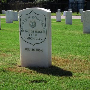 White marble grave marker with Medal of Honor inscription in cemetery