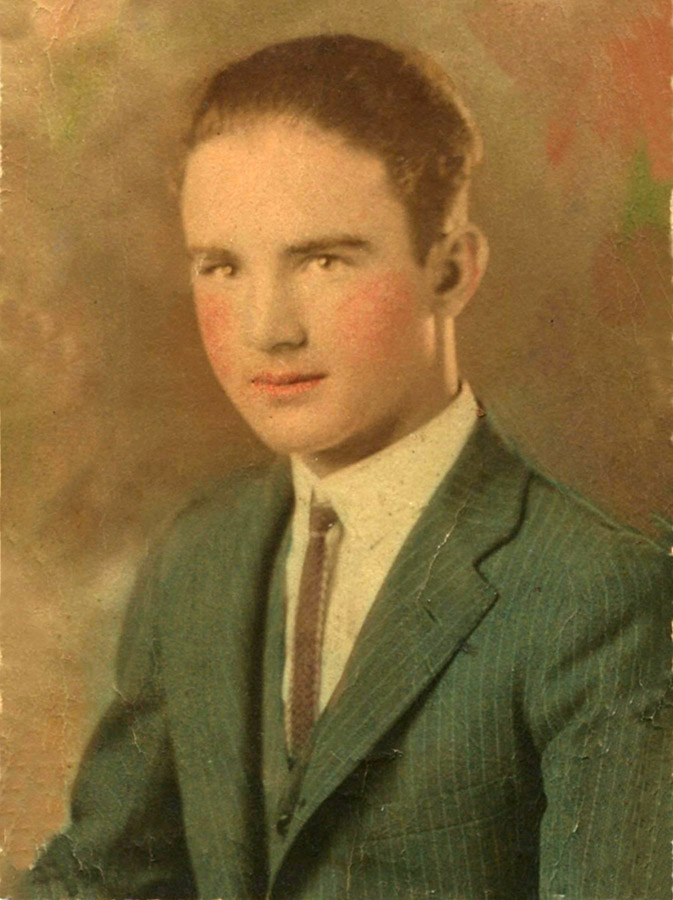 Young white man in green suit and tie