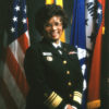Portrait black woman military uniform star badge name tag "Elders" various flags including U.S. and Arkansas