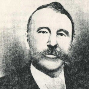 White man with mustache in suit