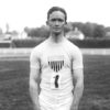 Young white man in olympic shirt and white shorts