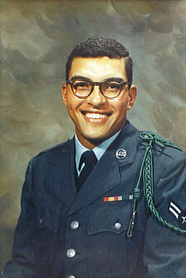 Young smiling African-American man in military uniform with glasses