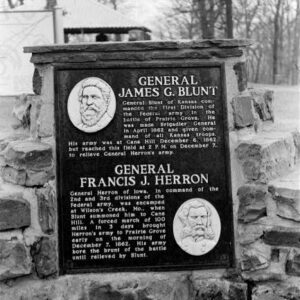 "General James G. Blunt" and "General Francis J. Herron" plaque with text and engraved portraits on it on brick wall