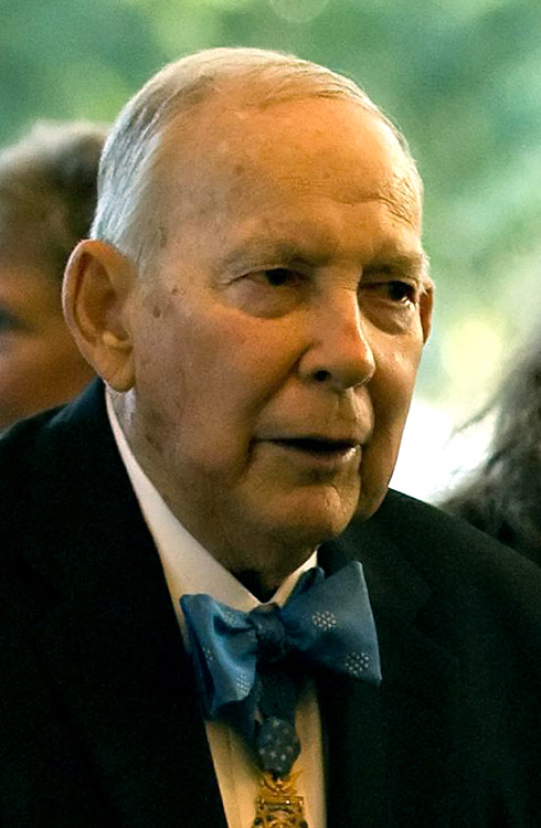 Old white man in suit and blue bow tie