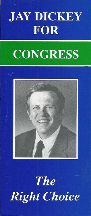 White man smiling in suit on blue white and green brochure