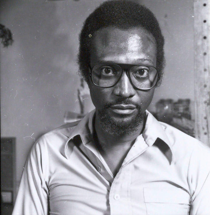 African-American man in glasses with beard and collared shirt