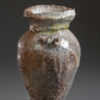 Handmade brown green and gray vase on gray background