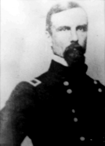 White man with dark hair beard and mustache in military uniform