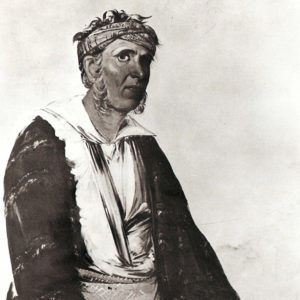 Native American man wearing a headband and robes
