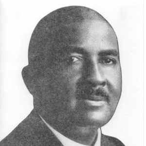 African-American man with mustache in suit