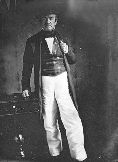 Cherokee man standing in hat and suit