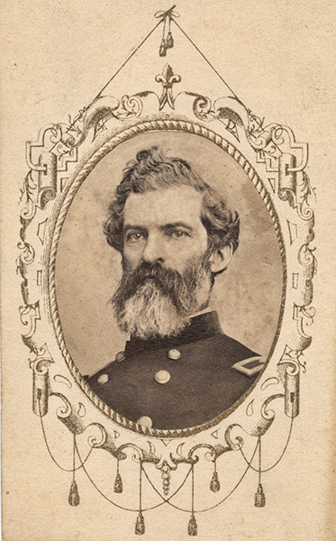 White man with curly hair and long beard in military uniform in oval frame