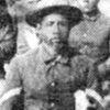 African-American man with beard in hat and suit