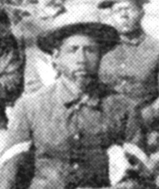 African-American man with beard in hat and suit