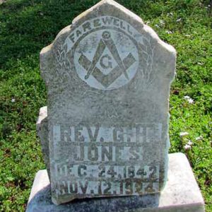 Grave marker with Masonic symbol and inscription on grass