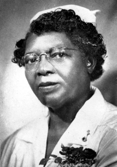 African-American woman with glasses in nursing uniform