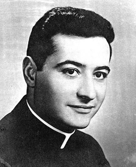 Young dark-haired white man in clerical collar