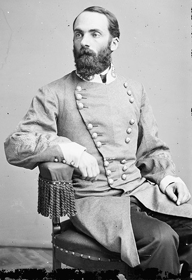 White man with beard sitting in gray military uniform