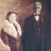 African-American woman in fur coat and hat standing with African-American man in suit and bow tie