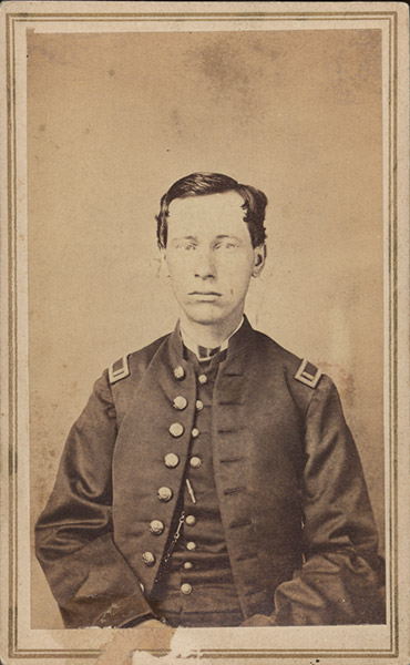 Young white man sitting in military uniform