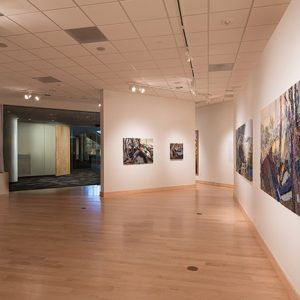 Museum gallery with paintings on walls and wood floors