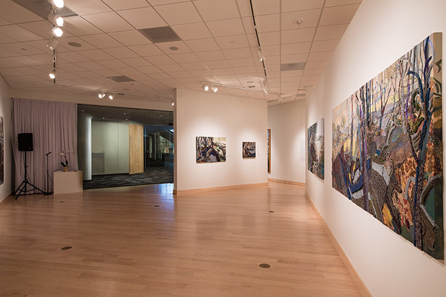 Museum gallery with paintings on walls and wood floors