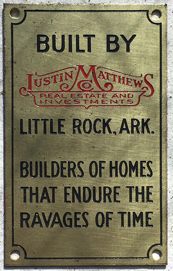 Engraved brass plaque with "Justin Matthews Real Estate and Investments" logo in red