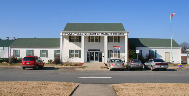 Two-story building with single-story wings and parking lot "Jacksonville Museum of Military History"