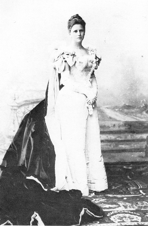 White woman in dress with train