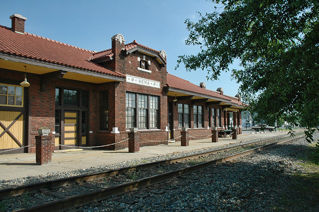 Brick train station and tracks on gravel