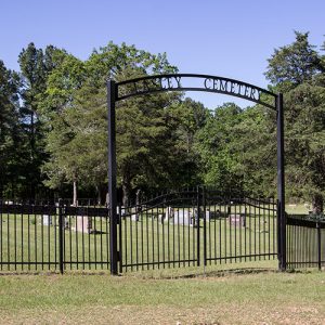 Cemetery with iron fence and arch over double gates